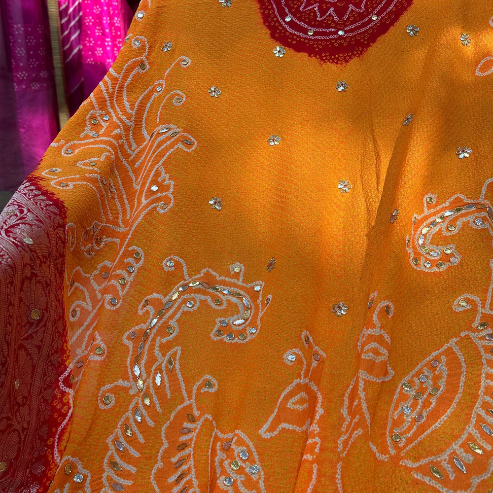 
                      
                        Peacock Peeliya — Orange Red Banarasi Bandhani with Gota Patti
                      
                    