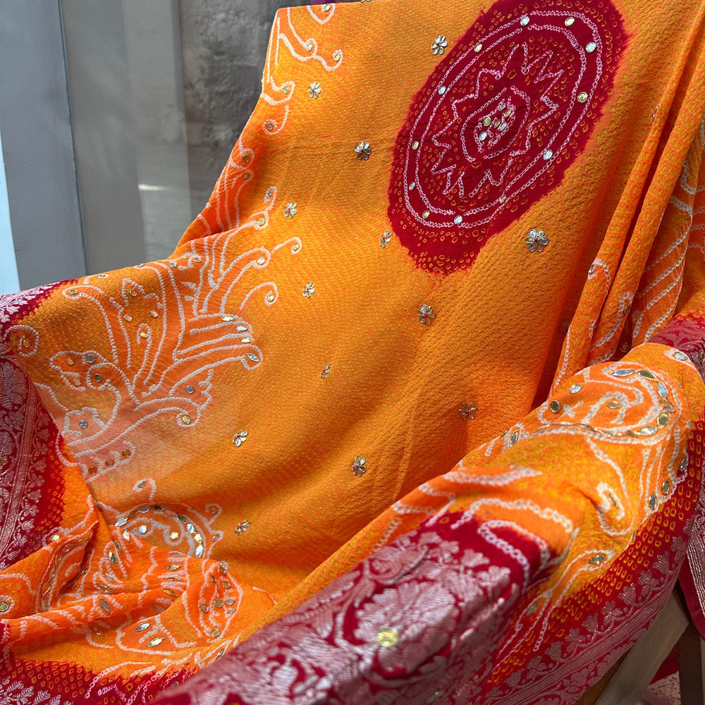 
                      
                        Peacock Peeliya — Orange Red Banarasi Bandhani with Gota Patti
                      
                    