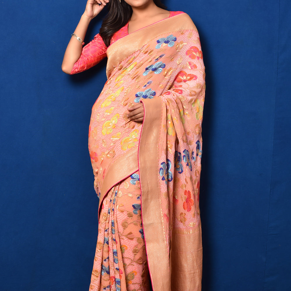 
                      
                        Floral Meenakari Motifs on a Peach Banarasi Bandhani Saree
                      
                    